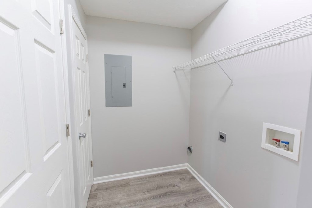 a white room with a closet and a door to a hallway