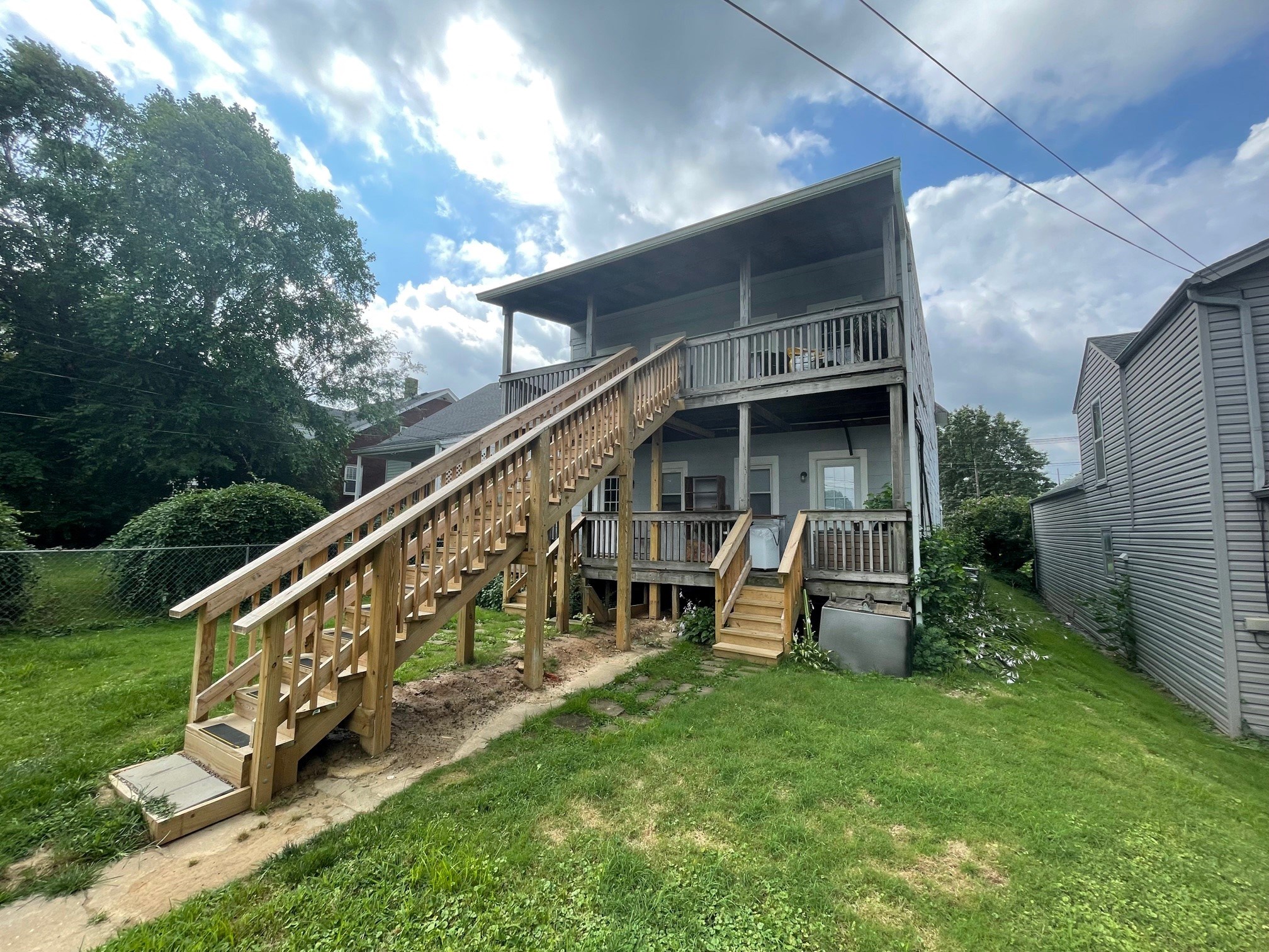 the back of a house with a deck and a staircase