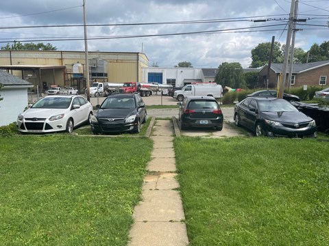 a parking lot full of cars in front of a building