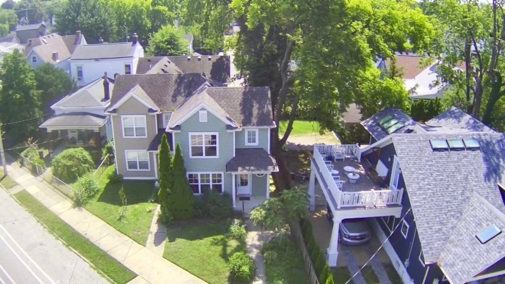 A bird's eye view of a residential area with houses and trees.