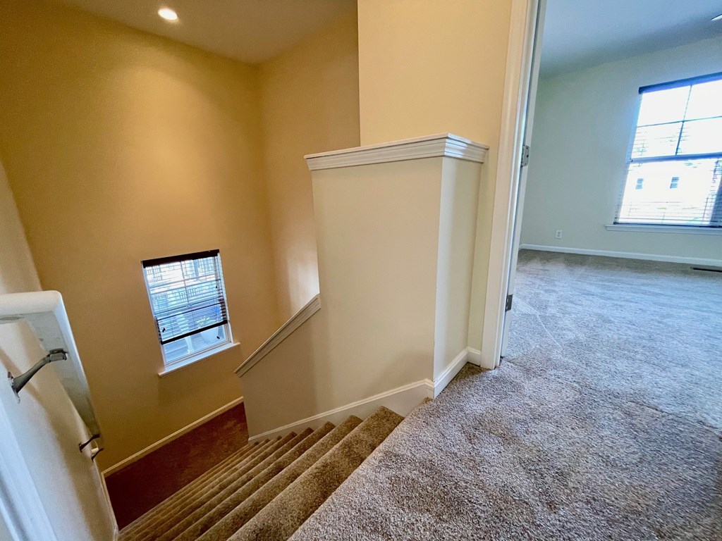 A room with a staircase and a window.