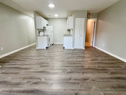 A kitchen area with white appliances and cabinets is shown.