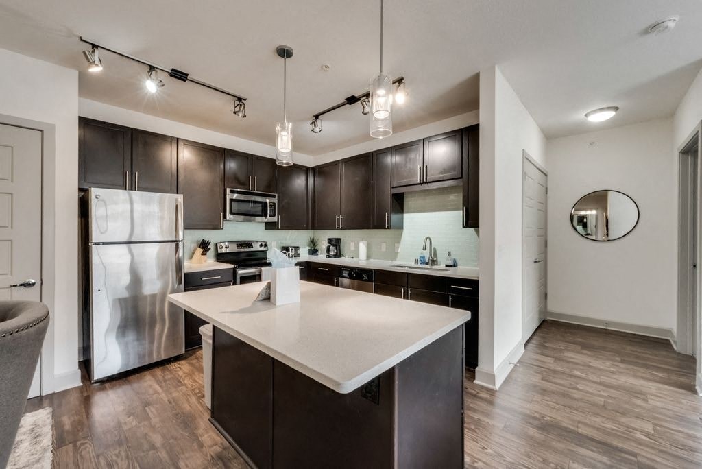 a kitchen with stainless steel appliances and a white counter top