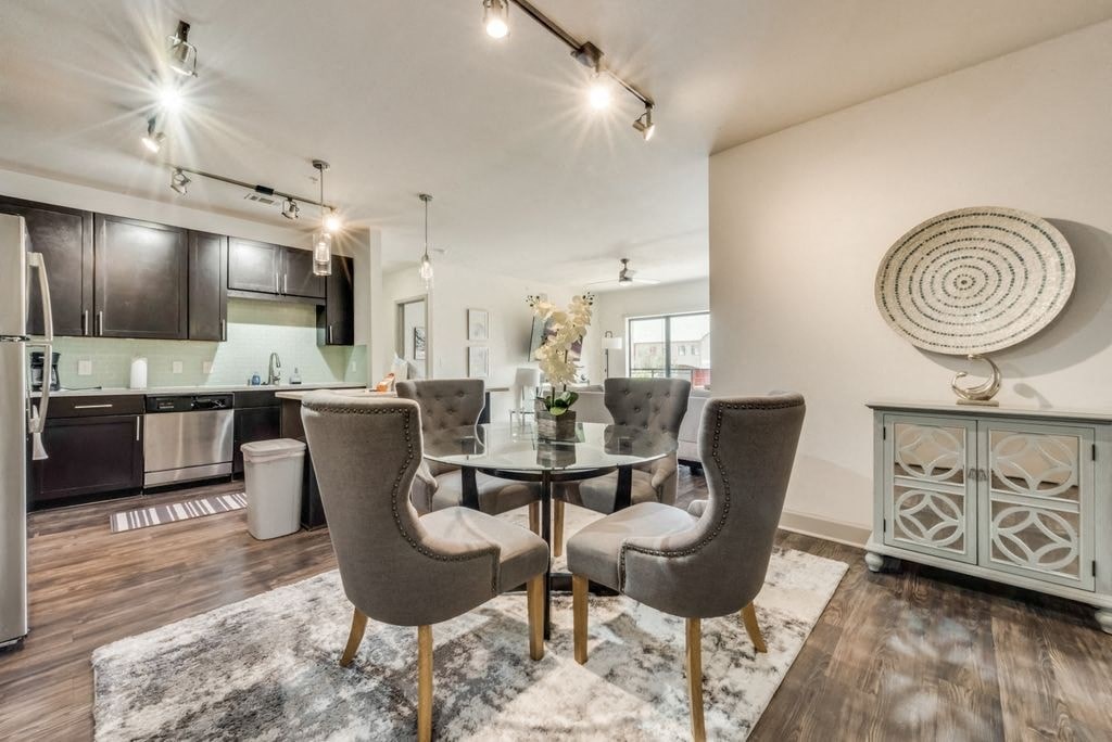 a dining room and kitchen with a table and chairs