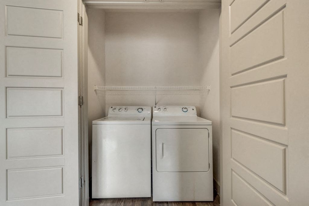 a washer and dryer in a laundry room with white doors