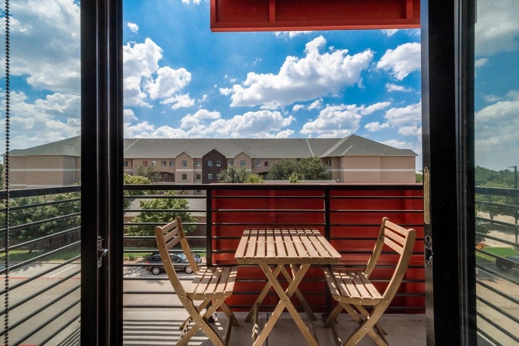 a patio with a table and chairs on a balcony