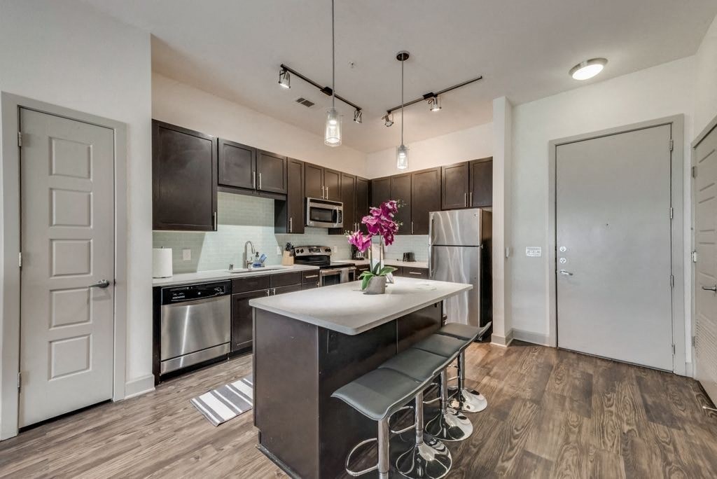 a kitchen with stainless steel appliances and a white counter top