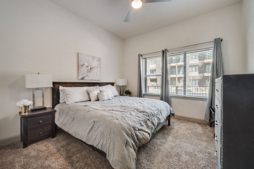 a bedroom with a bed and two windows