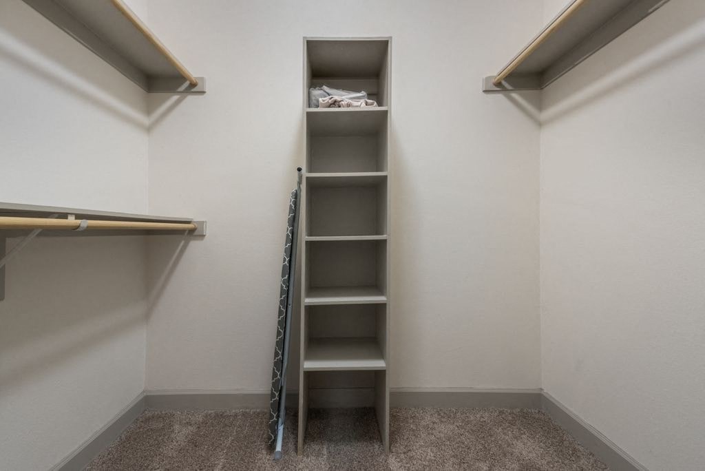 a tall shelf in a closet in a room