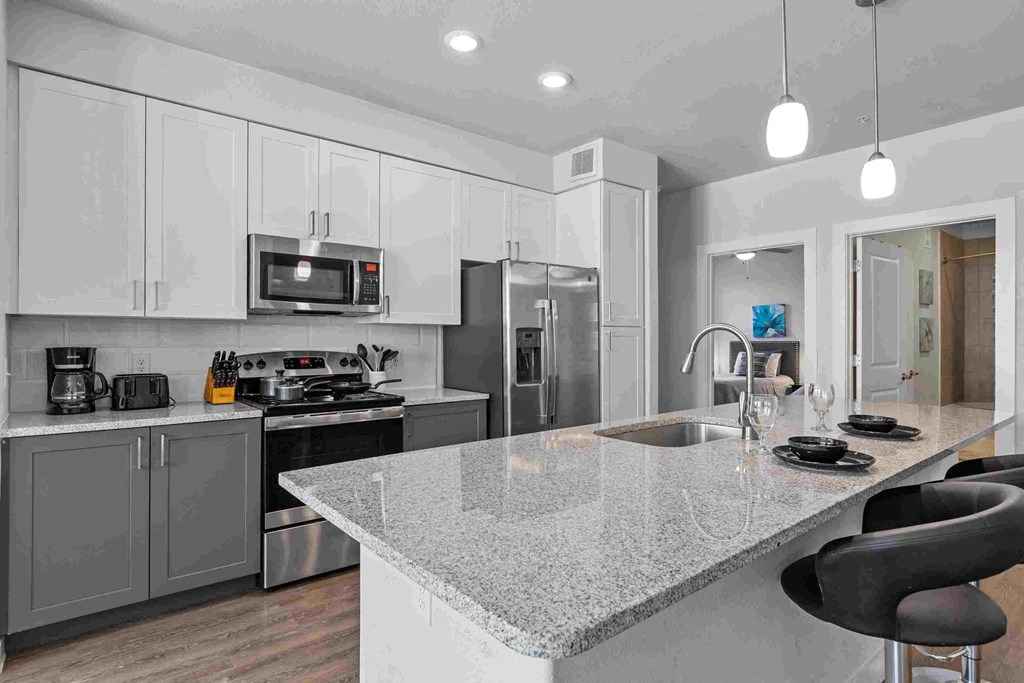 a kitchen with a marble counter top and a sink