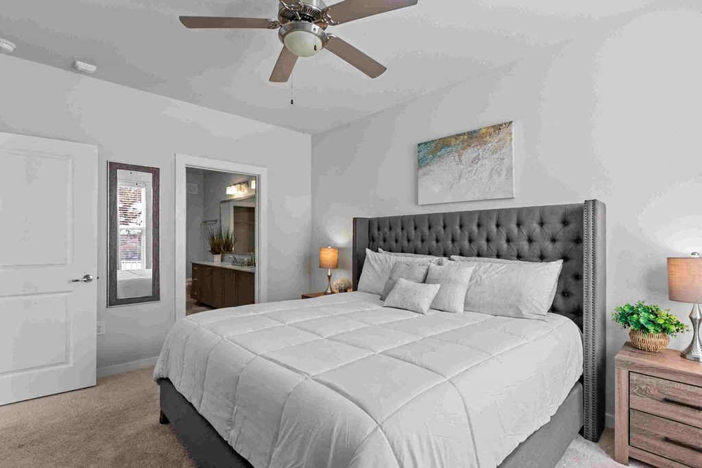 a bedroom with a bed and a ceiling fan