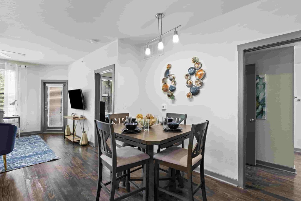 a dining room with a wooden table and chairs