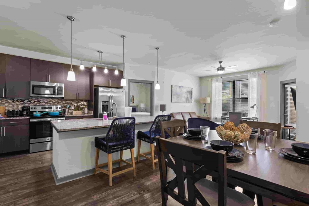 a kitchen and dining room area with a table and chairs