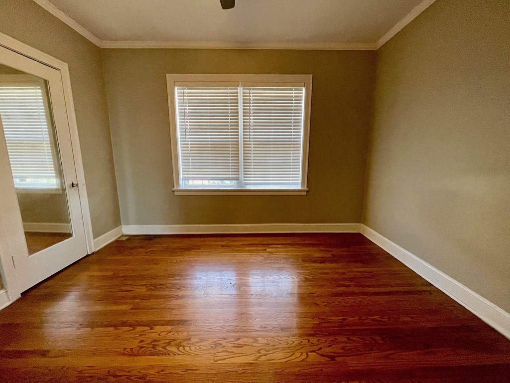 a empty room with wooden floors and a window