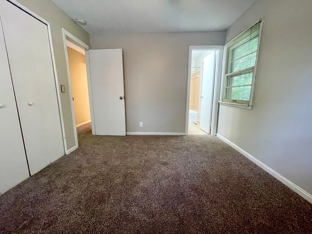 A room with carpeted floor and white walls.