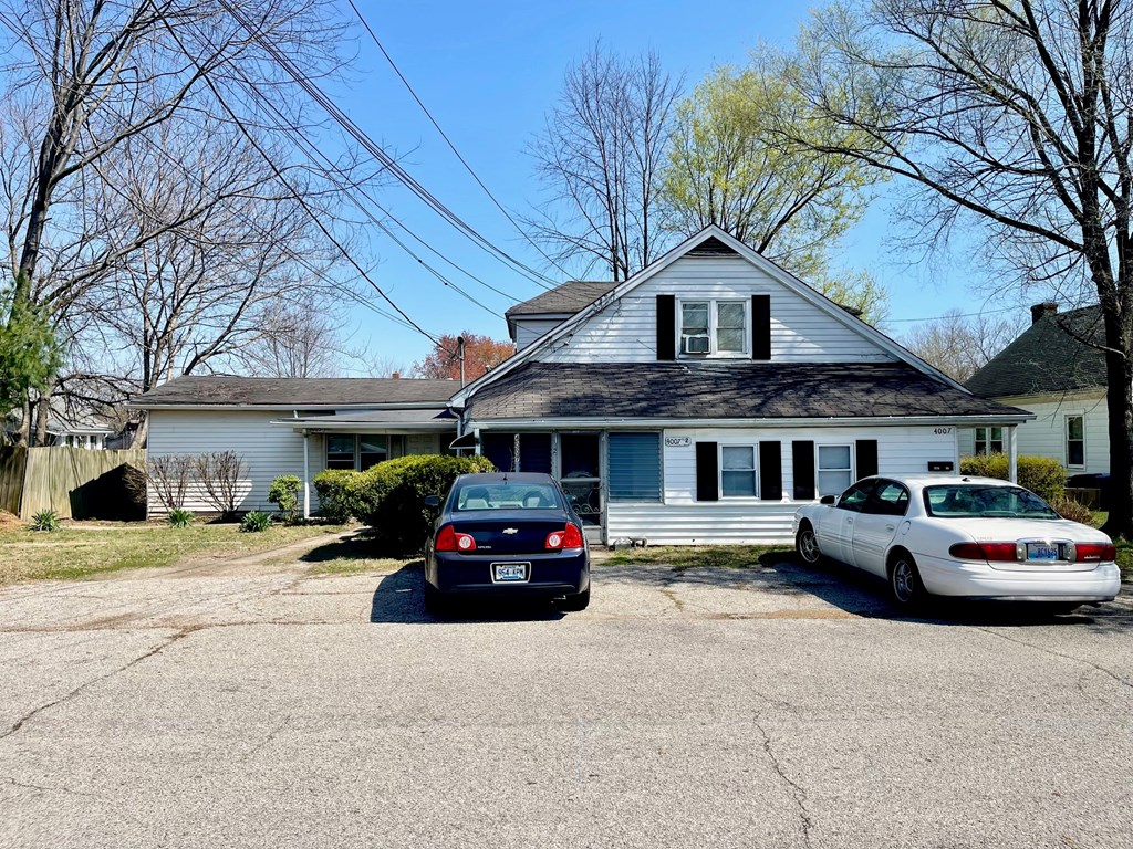 a house with two cars parked in front of it