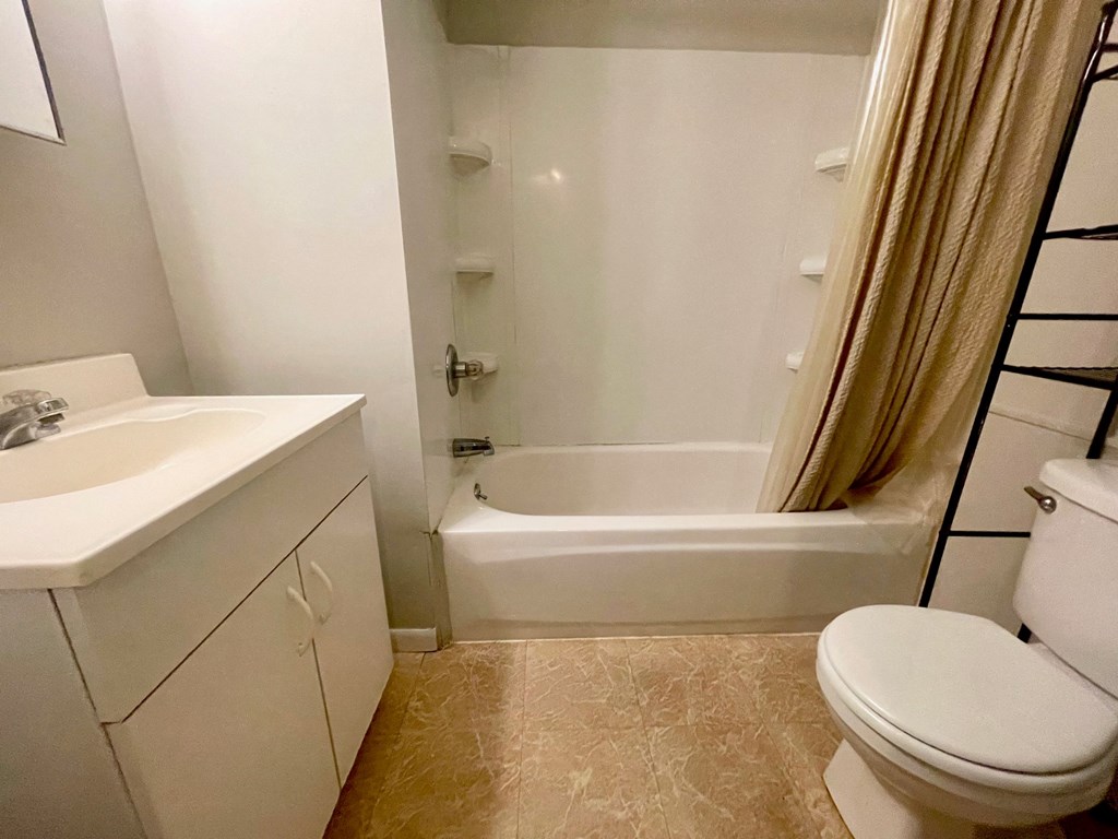 a bathroom with a sink toilet and a tub