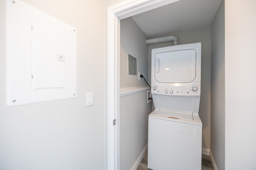a small laundry room with a washer and dryer and a window