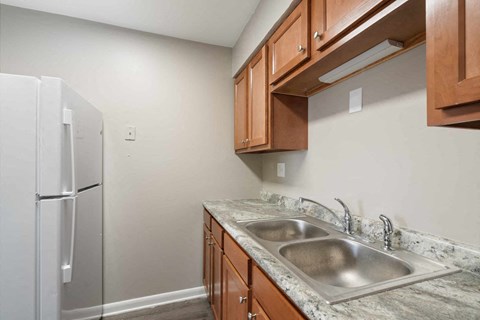 a kitchen with a sink and a refrigerator
