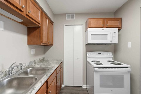 a kitchen with a stove microwave and sink
