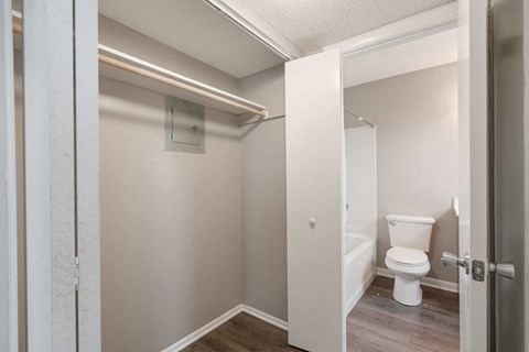 a small bathroom with a toilet and a walk in closet