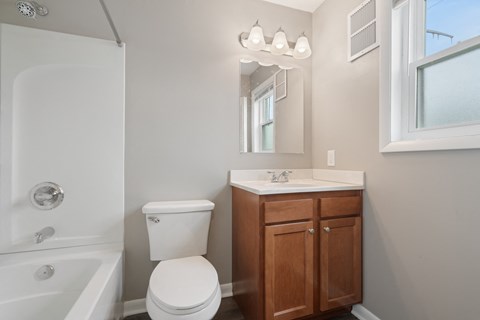 an empty bathroom with a toilet and a sink