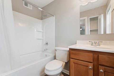 a bathroom with a sink toilet and a tub