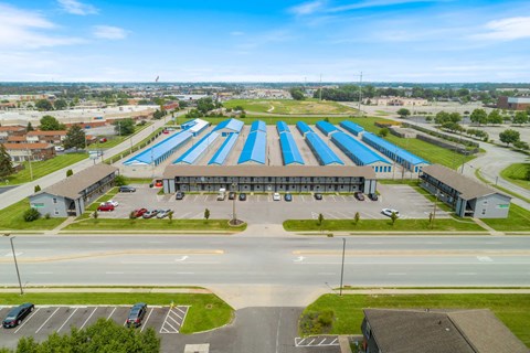 an aerial view of a large building with blue roofs