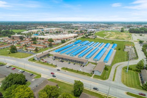 an aerial view of a large building with a blue roof
