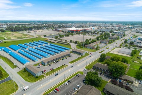 an aerial view of a large industrial facility with blue roofs
