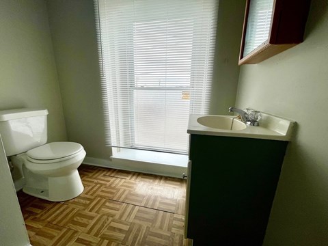 an empty bathroom with a toilet and a sink
