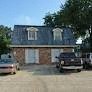a house with a blue roof and a truck parked in front of it