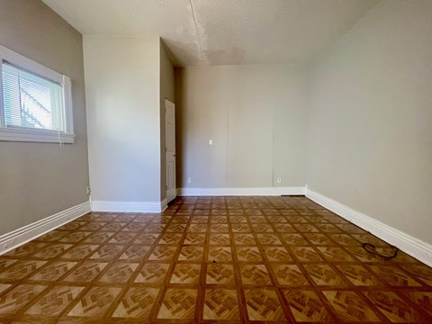 A room with a brown patterned floor and a window.