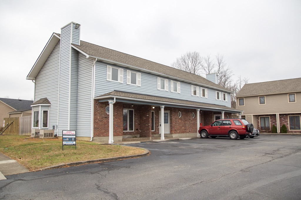 a house with a red car parked in front of it
