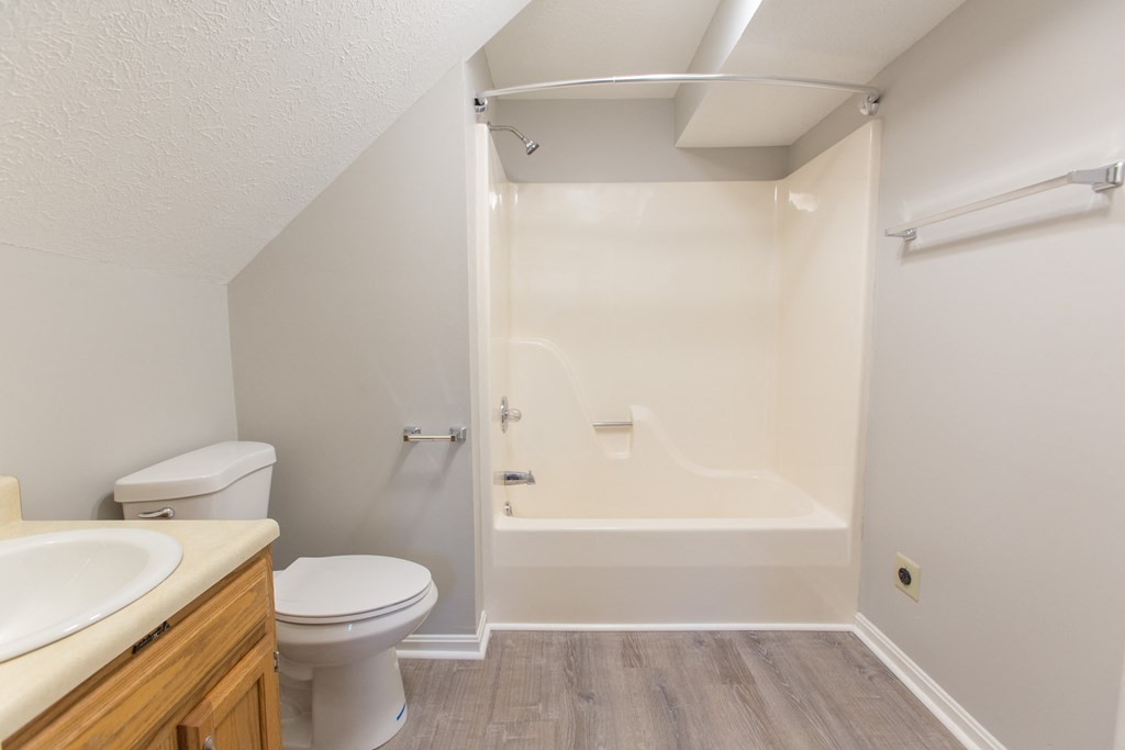 an empty bathroom with a toilet and a shower