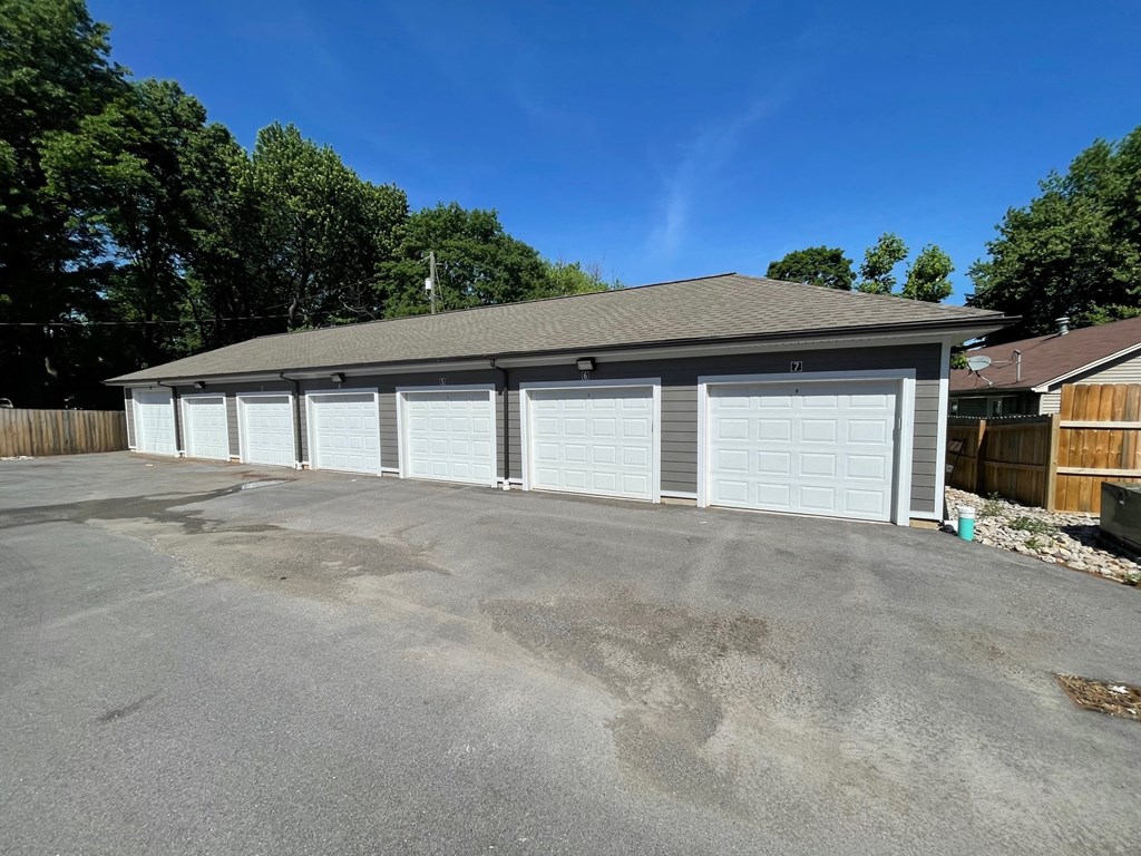 a 4 car garage with a row of white garage doors