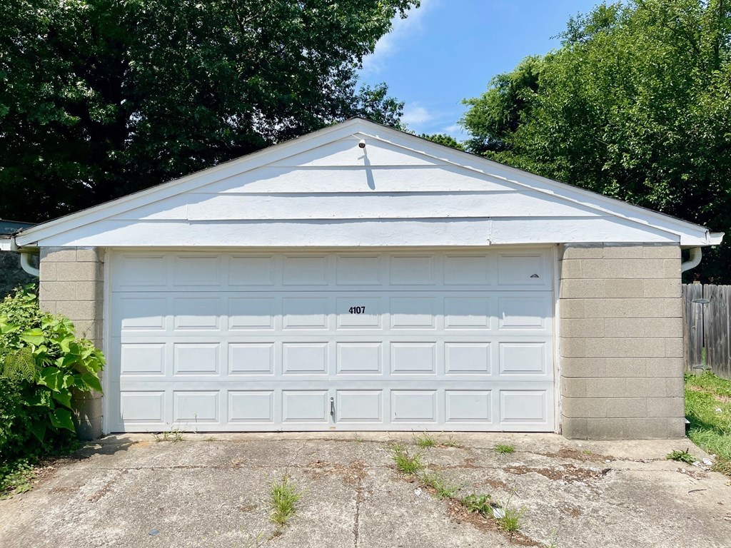 a garage with a white garage door on the side of it