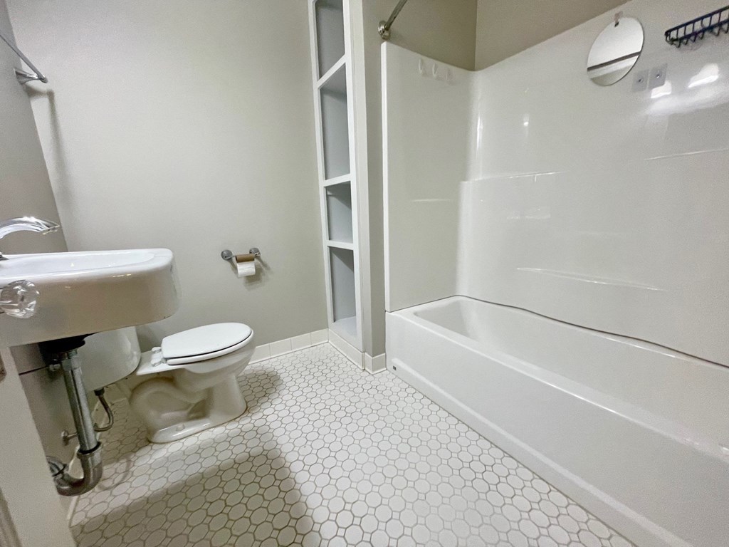 a bathroom with a toilet and a tub and a sink