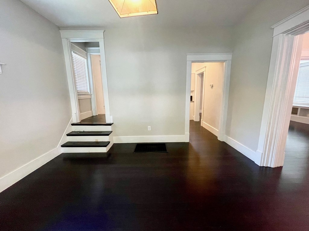 a living room with a hard wood floor and stairs