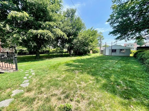 a backyard with a house and a yard with grass and trees