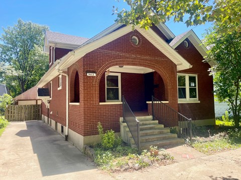 a red brick church with stairs in front of it