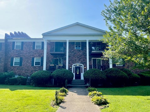 A large house with a front porch and a white door.