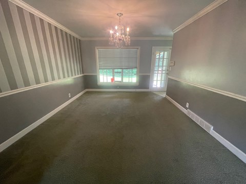 a empty dining room with a chandelier