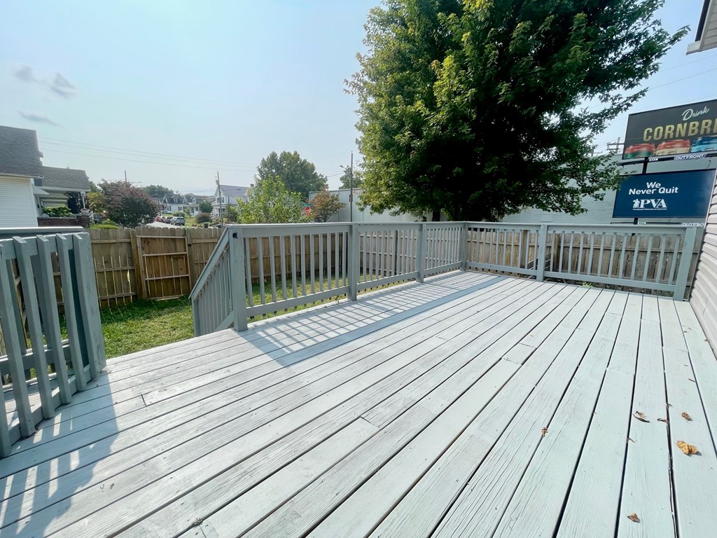 A wooden deck with a sign that says Cornbread in the background.