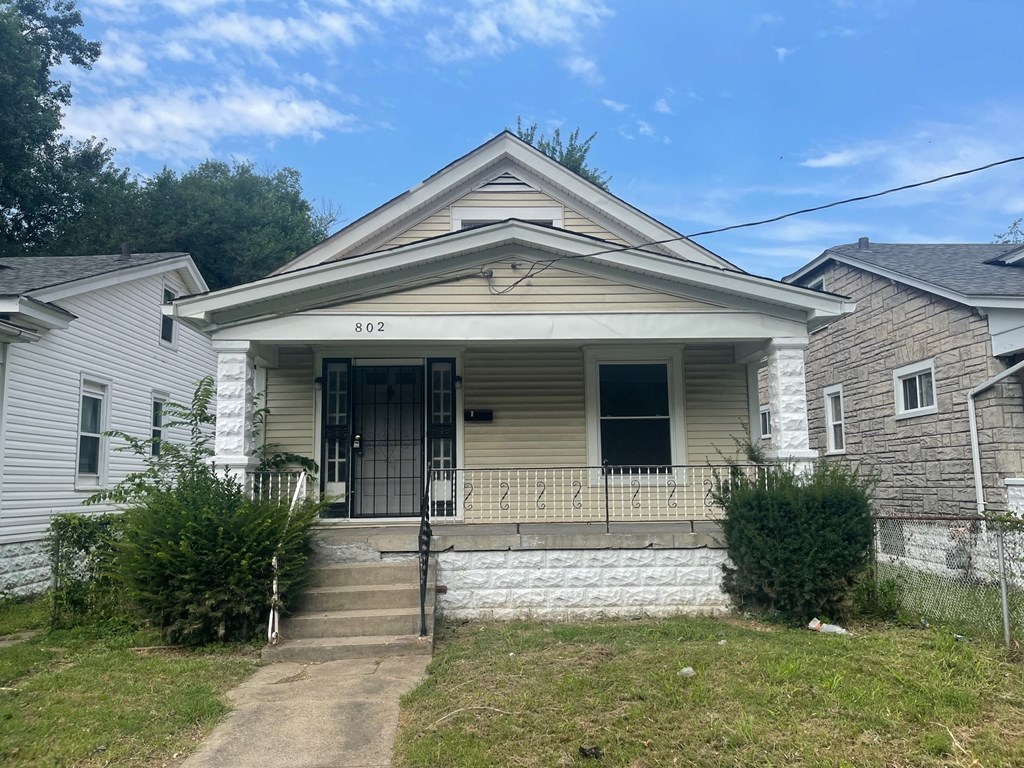 a white house with a front porch and stairs