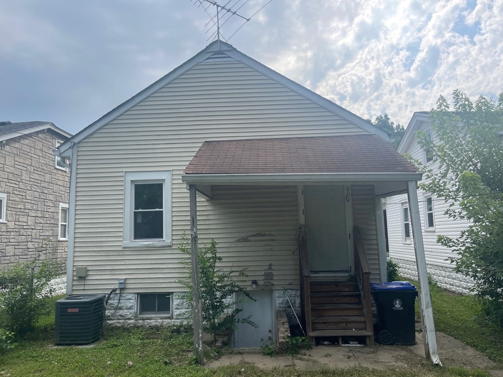the front of a house with a roof on top of it