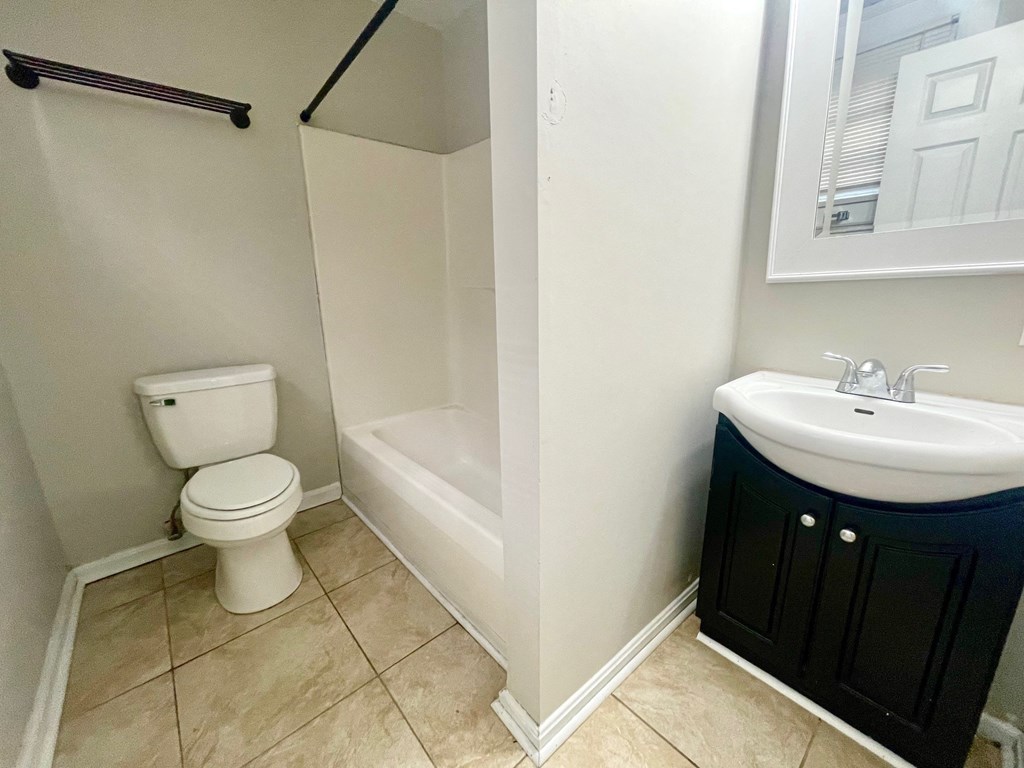 a bathroom with a toilet and a sink and a shower