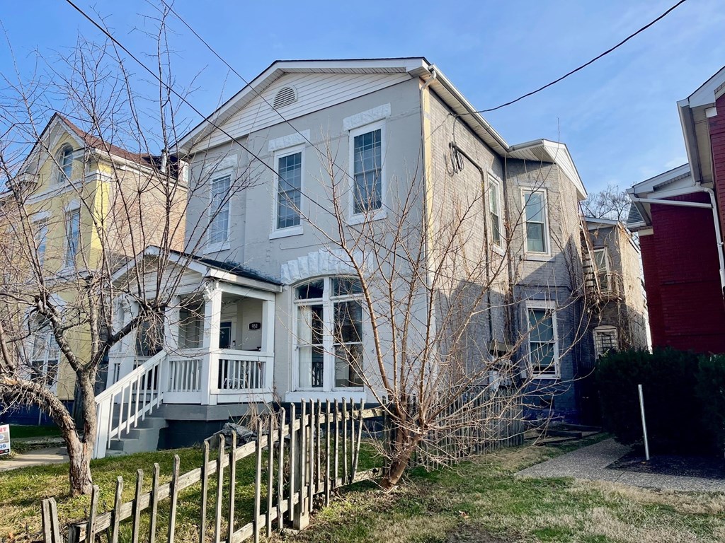 a white house with a white fence in front of it