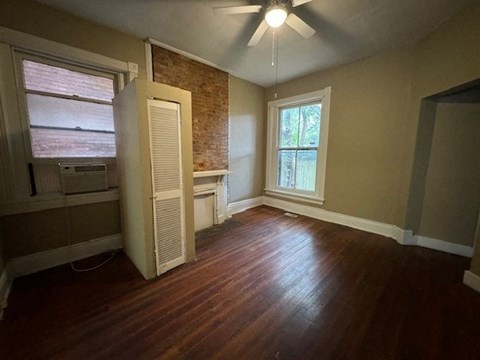 an empty room with a closet and a window