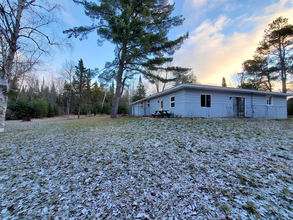 a white house with a yard covered in snow